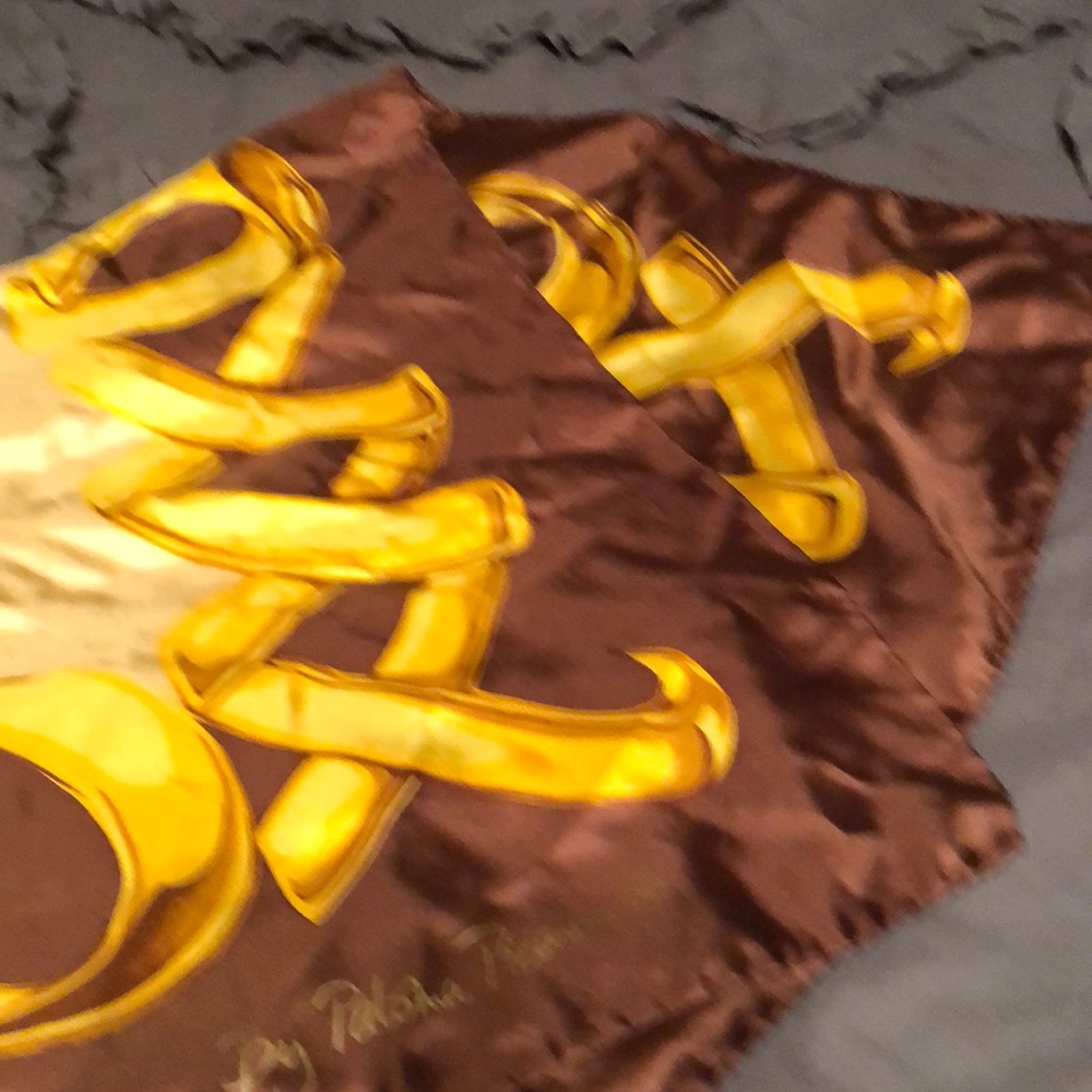 Pure silk scarf by Paloma Picasso, 33”x 34”. One tiny pin hole as indicated.